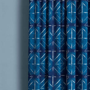 Detail of tie dye pattern curtain with large white diamond on indigo.