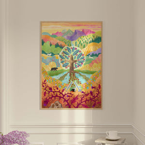 A colorful framed Garden of Eden art print depicting a stylized tree with patterned leaves, mountains, and abstract landscape elements.