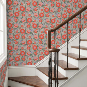 Staircase with wooden steps and a floral patterned wall.